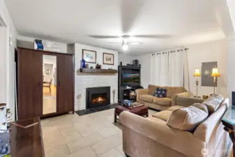 Another view of the comfortable living room featuring fireplace focal point and easy connection to the rest of the home.