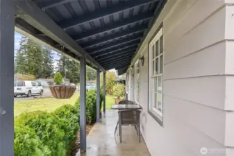 Covered front porch offers a comfortable spot to relax and enjoy the neighborhood setting year-round.