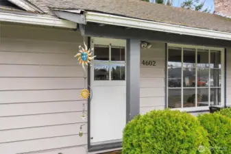 Inviting front porch entry with covered sitting area and easy access into the home.