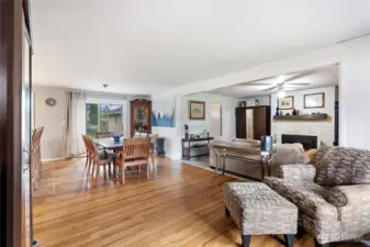 Spacious interior view showing the open flow from the living area into the dining space and updated kitchen.