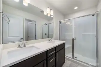 Double vanities in primary bath, along with a large walk-in shower.