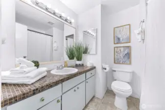 Spacious full bathroom with tub.