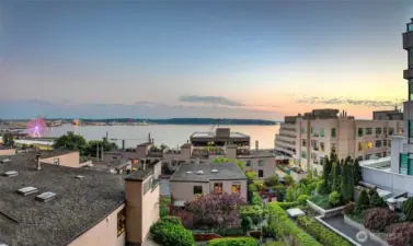 Pink sunset views overlooking Puget Sound and manicured courtyards below.