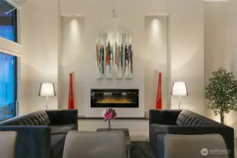Stunning symmetry in the living room with art niches and a modern electric fireplace.