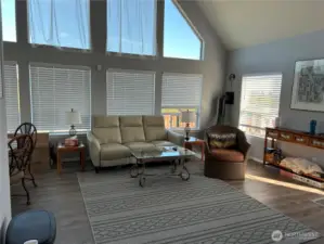 Beautiful new blinds move up and down just by manual lifting and open to territorial views to watch the deer  New laminate flooring in living room, kitchen and hall areas of the home.