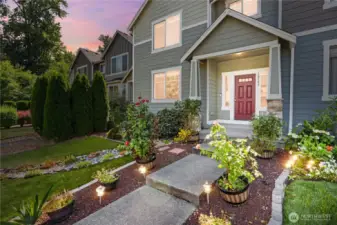 Welcome Home! Turf lawn, easy-care plantings and landscape. Solar lights make the entry extra welcoming!