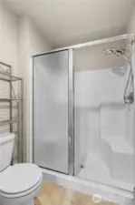 Primary En Suite Bath continues w/an Oversized Shower w/Bench and Upgraded Shower Head.