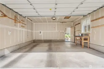 Very Clean Garage is fully finished with window and door to backyard. Garage Door comes with opener. Work Bench stays