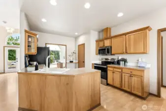 Beautifully laid out open-concept kitchen, living room, dining room with large amounts of storage and counter space with natural oak cabinetry, porcelain white sink, new appliances with natural light galore. Enjoy the hard surface hardwood laminate flooring throughout.