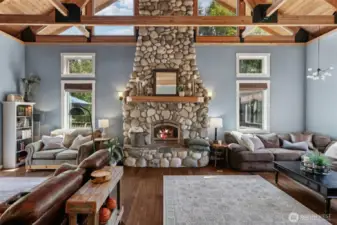 A stunning river rock fireplace commands the room with its rugged elegance, becoming the natural gathering place where warmth sparks connection and conversation.