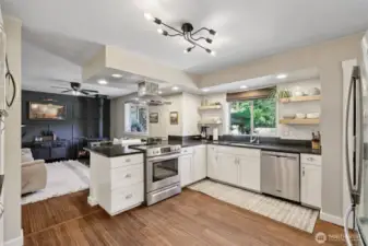 Stainless steel appliances and range hood add to the modern elegance of the space.