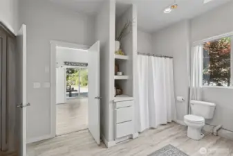 Downstairs from the main floor of the home, you will find this large full bathroom complete with the laundry and utility space.