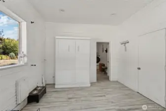 This additional guest or flex room off the laundry area features a convenient Murphy bed—easily tucked away to keep the space functional and versatile when not hosting overnight visitors.