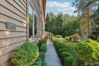 Sidewalk that leads to the front door and deck.