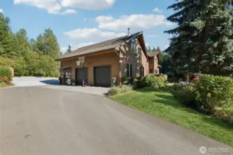 Large two-car garage with plenty of storage and 220V power.