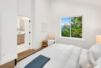 Upper level primary suite has a 3/4 bath, walk-in closet and vaulted ceilings.