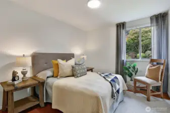 Spacious main floor bedroom #1, looking into beautiful backyard.