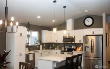 Kitchen with large island finished in Quartz countertops.