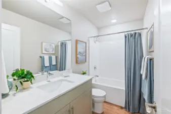 Upper Level guest bath with tub shower combo. Quartz counters and under mount sinks.
