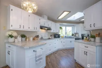 Ample cabinetry and sleek, spacious counters create an ideal setting for effortless meal prep and entertaining. A full suite of sleek stainless-steel appliances adds contemporary elegance.