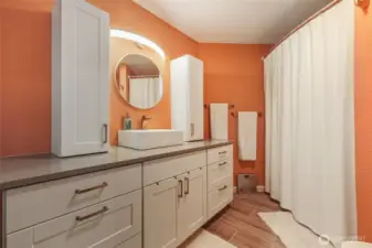 Colorful primary bath with tile flooring and stunning cabinetry.