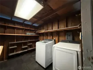 Storage room connected to Carport has Washer and Dryer