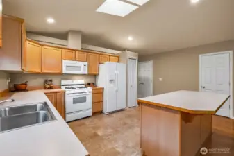 Two pantry closets, skylight, island, gas stove.