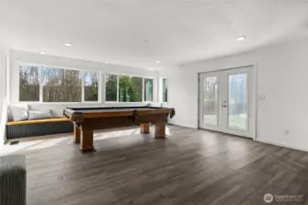 This large light filled bonus space is part of the family room. Through the french doors leads you to the back patio and yard.