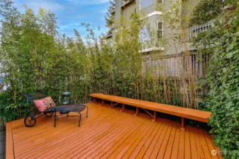 The shared back deck has a built-in bench for additional seating.