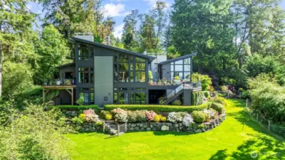 Every angle of this modern masterpiece is intentional. From the geometry of the rooflines to the tiered garden beds, this rear façade speaks to architectural boldness and refined outdoor living.