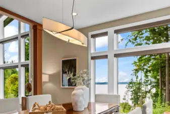 Architectural lighting meets gallery-worthy surroundings. The dining area is a curated moment—bright, stylish, and anchored by ever-changing views.