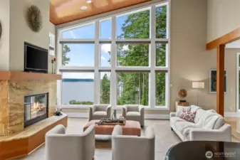 This showstopping living space features a stone-framed fireplace and an artistic expanse of glass with striking Puget Sound views. The architecture is sculptural, the atmosphere is refined, and the setting is simply unforgettable.