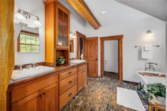 Primary Spa bath boasts double vanities, claw foot soaking tub, custom stone shower & walk-in closet.