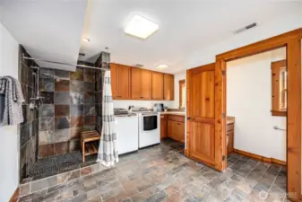 Luxurious Laundry with ample storage, shower and half bath.