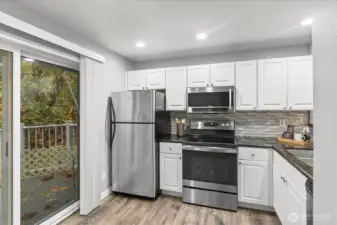 Plenty of prep space meets polished design — slab granite counters for your culinary creations and a full-height backsplash that ties the entire kitchen together beautifully.