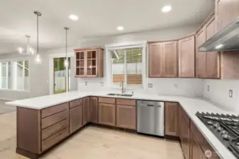 Kitchen opens into nook and a spacious living area with large windows creating a seamless flow ideal for both everyday living and entertaining.