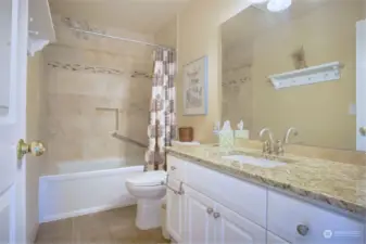 Hall bath on this level with soaking tub with Travertine surround and floors. Slab granite counter.