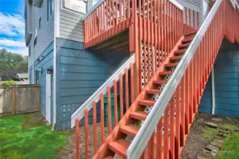 View coming down into private fenced yard from the decks.