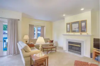 Living room with gas fireplace and door to the front deck.