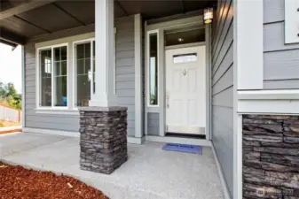 Stone columns on porch and garage panels. Photo for illustration only, not actual.