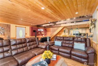 Cozy Main Floor Living Area    Relax in style with reclining sofas, a smart TV equipped for streaming, and charming tongue-and-groove wood accents that add warmth and character to this inviting space.