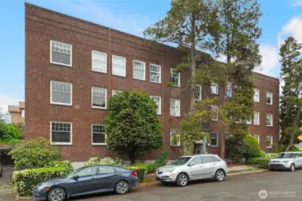 Glowing light-filled Corner Unit Home with Gracious and Spacious Living Room! The Hombroness is a handsome 1925 classic brick building right at the heart of Capitol Hill living. Classic & fanciful: inherent era charm, hi ceilings, charming breakfast nook, leaded glass built-in & a circular flr plan conveniently connecting the spaces. JUST REFRESHED w/new paint, lovely quartz counter w/undermount sink & faucets, refinished butcher block counter, blinds. Dues cover many expenses: heat,hot water,water,sewer,garbage. No rental cap, 30-day min rental allowed, pet-friendly, storage unit. 97 Walk Score: steps to lightrail, walk Dwtn or to SLU, bus/bike/rail to UW/SU. All the retail fun you could ever desire on Broadway, Pike/Pine, Volunteer Park!