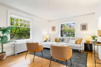 Gracious and spacious living room that glows with natural light from 2 sides in this corner home!