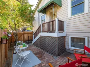 The kitchen door opens to this charming Brick Patio, a private retreat in the City.