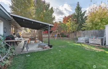 Large backyard ready for gardening and relaxing.