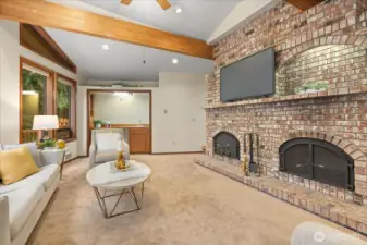 Vaulted ceilings & exposed wood beams perfectly highlight your beautiful Russian brick fireplace. Your sunken living room is an ideal entertaining room offering a wet bar with built-ins & a door that leads out to your  expansive deck.