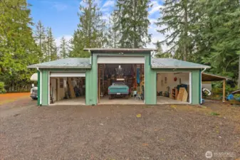 6 car garage with carport! A mechanic's dream with high bay door, power, heat & plumbed for an air compressor! RV parking is effortless  with a dump station & a circular driveway. You'll find additional shelter with the carport.