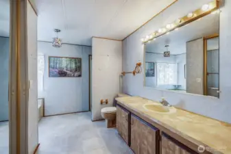 This spacious primary bath provides a long vanity.