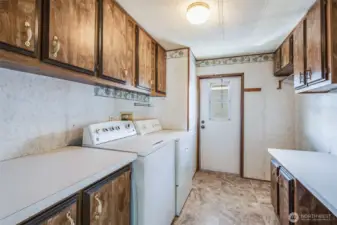 Off the back stairs is the utility room with washer and dryer that stay with the home.