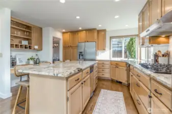 So many great kitchen features - granite counters, tiled backsplash, trash compactor, coffee/wine bar